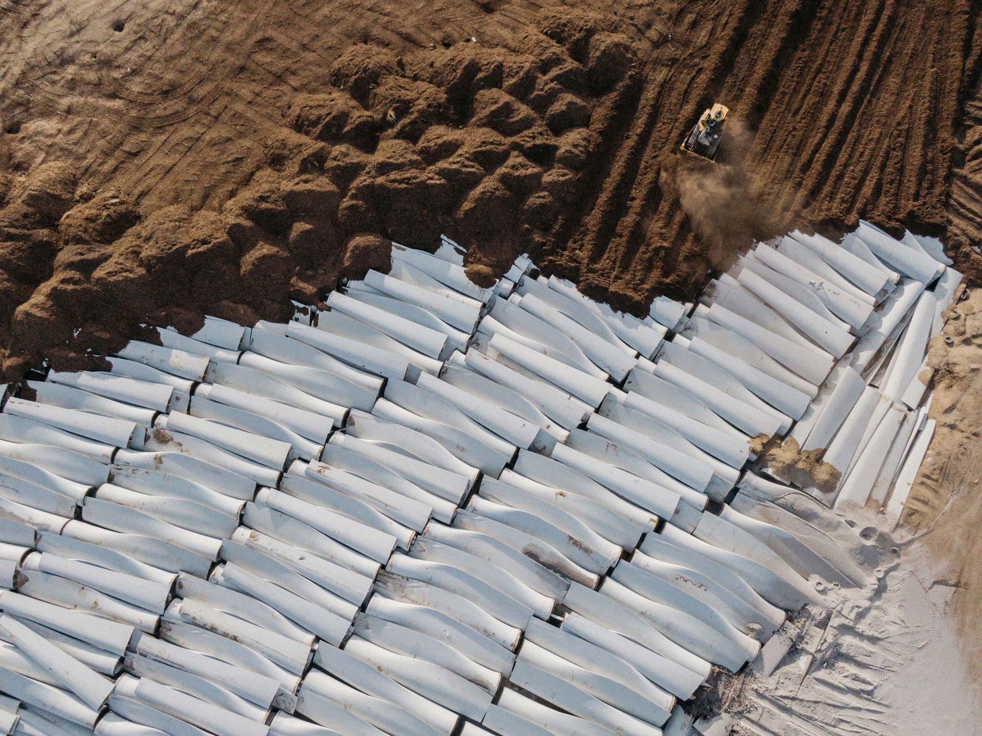aerial shot of huge blades in rows in a landfill